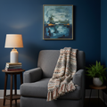 Cozy reading nook with deep blue wall, comfortable chair, warm lamp, and meaningful art